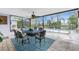 Enclosed pool area with dining table, fan, and stunning view of the pool and the lake at 330 Weber Ter, Port Charlotte, FL 33952