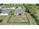 An aerial view of a backyard with a black fence enclosing a green lawn and view of the rear of the house at 3631 Pebble Ter, Punta Gorda, FL 33980