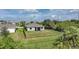 A backyard with a black fence enclosing a green lawn and view of the rear of the house at 3631 Pebble Ter, Punta Gorda, FL 33980