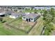 An aerial view of a backyard with a black fence enclosing a green lawn and view of the rear of the house at 3631 Pebble Ter, Punta Gorda, FL 33980