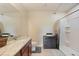 Bathroom includes granite countertop, storage cabinet, and a shower with patterned curtain at 3631 Pebble Ter, Punta Gorda, FL 33980