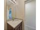 Bathroom featuring granite countertops, a reflective mirror, and neutral paint at 3631 Pebble Ter, Punta Gorda, FL 33980