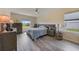 Comfortable bedroom with modern furnishings, wood-look flooring, and a bright window at 3631 Pebble Ter, Punta Gorda, FL 33980