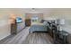 Well-lit bedroom with wood-look flooring, modern furniture, and a view of the outdoors at 3631 Pebble Ter, Punta Gorda, FL 33980