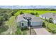 Stylish single-Gathering home with brick paver driveway with a backdrop of green space at 3631 Pebble Ter, Punta Gorda, FL 33980