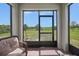 Comfortable screened-in patio area with views of the fenced-in backyard and lush greenery at 3631 Pebble Ter, Punta Gorda, FL 33980