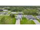 This aerial view shows a property with a metal workshop, lush lawns and perimeter fencing at 369 Hyacinth St, Port Charlotte, FL 33954