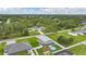 An aerial view showing the home's backyard pool with a treed landscape and neighborhood at 369 Hyacinth St, Port Charlotte, FL 33954