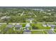 An aerial view of a neighborhood showing the treed landscape, and backyard pools at 369 Hyacinth St, Port Charlotte, FL 33954