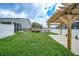 View of a well-maintained backyard with a pergola, deck, and above-ground pool at 369 Hyacinth St, Port Charlotte, FL 33954