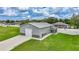 Exterior angle of a gray house with a garage, screened porch, white fence and trimmed green grass at 369 Hyacinth St, Port Charlotte, FL 33954