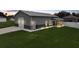 Exterior angle of a gray house with a garage, screened porch, and trimmed green grass at 369 Hyacinth St, Port Charlotte, FL 33954
