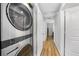 Hallway featuring front load washer and dryer and hardwood floors at 369 Hyacinth St, Port Charlotte, FL 33954