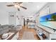 Inviting living room featuring a gray sectional sofa, wood floors, and an open layout to the kitchen at 369 Hyacinth St, Port Charlotte, FL 33954