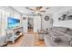 Comfortable living room with a gray sectional sofa, wood floors, and a sliding barn door to the office at 369 Hyacinth St, Port Charlotte, FL 33954