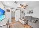 Comfortable living room with a gray sectional sofa, wood floors, and sliding barn doors to other rooms at 369 Hyacinth St, Port Charlotte, FL 33954