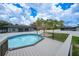 View of the backyard featuring an above ground pool with deck and pergola, creating a relaxing outdoor oasis at 369 Hyacinth St, Port Charlotte, FL 33954
