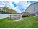 Backyard view featuring an above-ground pool with deck and pergola, ready for outdoor enjoyment at 369 Hyacinth St, Port Charlotte, FL 33954