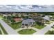 Aerial view of a stunning waterfront home, featuring a paver drive, two-car garage, and lush tropical landscaping at 3800 Carupano Ct, Punta Gorda, FL 33950