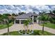 Expansive aerial view of luxury home with manicured lawn, lush landscaping, and circular driveway at 3800 Carupano Ct, Punta Gorda, FL 33950