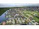 Panoramic aerial view of a waterfront community with homes nestled along winding canals, near a golf course at 3800 Carupano Ct, Punta Gorda, FL 33950