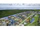 Expansive aerial view of a waterfront community featuring private canals and lush landscaping near a large open body of water at 3800 Carupano Ct, Punta Gorda, FL 33950