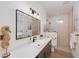 This bathroom has a walk-in shower, long vanity, and modern fixtures at 3800 Carupano Ct, Punta Gorda, FL 33950