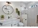 Beautiful bathroom with stylish subway tile and a large round mirror at 3800 Carupano Ct, Punta Gorda, FL 33950