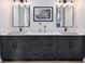 Bathroom with a double vanity, quartz countertops, and modern light fixtures at 3800 Carupano Ct, Punta Gorda, FL 33950