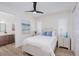 Bedroom featuring a comfortable bed with blue pillows and wood look tile at 3800 Carupano Ct, Punta Gorda, FL 33950
