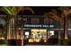 Exterior view of the Fisherman's Village under a bright sign at night at 3800 Carupano Ct, Punta Gorda, FL 33950