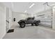 Spacious garage with an epoxy floor and high ceilings, showcasing ample room for vehicle storage and additional shelving at 3800 Carupano Ct, Punta Gorda, FL 33950