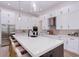 Bright kitchen with a large island, white cabinetry, stainless steel appliances, and pendant lighting at 3800 Carupano Ct, Punta Gorda, FL 33950