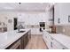 Modern kitchen with white cabinets, stainless steel appliances, and an island with countertop seating at 3800 Carupano Ct, Punta Gorda, FL 33950