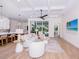 Bright living room boasts an open concept with the kitchen and dining area, leading to a screened outdoor patio at 3800 Carupano Ct, Punta Gorda, FL 33950