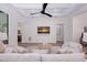 Relaxing living room featuring a coffered ceiling, neutral furniture, and a wall-mounted TV with beach scene art at 3800 Carupano Ct, Punta Gorda, FL 33950