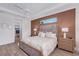 Comfortable main bedroom featuring a tray ceiling, accent wall, and access to the ensuite bathroom at 3800 Carupano Ct, Punta Gorda, FL 33950