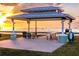 Community pavilion with picnic tables overlooking the water at sunset at 3800 Carupano Ct, Punta Gorda, FL 33950