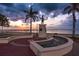 Waterfront plaza featuring a statue, fountain, and scenic views of the water and sunset at 3800 Carupano Ct, Punta Gorda, FL 33950