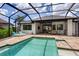 Screened-in pool area with lounge chairs and an outdoor dining set at 3800 Carupano Ct, Punta Gorda, FL 33950