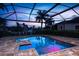 Beautiful outdoor pool with a screened lanai and a waterfront view in the distance at 3800 Carupano Ct, Punta Gorda, FL 33950
