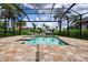 Refreshing screened-in pool with a brick paver deck, perfect for relaxation and outdoor entertainment at 3800 Carupano Ct, Punta Gorda, FL 33950