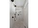 Walk-in shower features floor-to-ceiling tile and a pebble floor at 3800 Carupano Ct, Punta Gorda, FL 33950