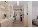 Spacious walk-in closet with custom shelving and storage solutions, conveniently located near the luxurious bathroom at 3800 Carupano Ct, Punta Gorda, FL 33950