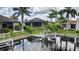 Aerial view of backyard with screened-in pool and boat lift on a waterfront property at 3800 Carupano Ct, Punta Gorda, FL 33950