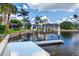 Scenic waterfront view featuring a private boat lift and lush tropical landscaping at 3800 Carupano Ct, Punta Gorda, FL 33950
