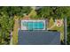 An aerial view showcases a pool with screened enclosure and a cozy fire pit area in the backyard at 3824 Dominic St, North Port, FL 34288