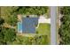Aerial view of house featuring pool, fire pit, large yard, and mature landscaping at 3824 Dominic St, North Port, FL 34288