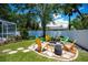 Enjoy outdoor living with this backyard firepit with patio and a lush lawn at 3824 Dominic St, North Port, FL 34288