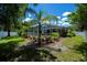 Large backyard with pool, patio, and tropical landscaping, enclosed by a privacy fence at 3824 Dominic St, North Port, FL 34288